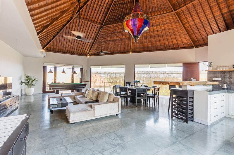 Upper floor: open living, dining and kitchen under the alang-alang ceiling