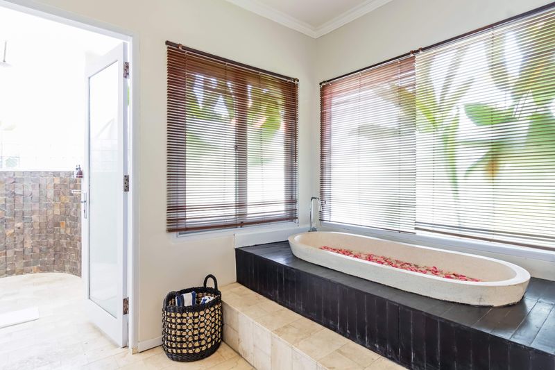 Deep bath set beneath a garden window